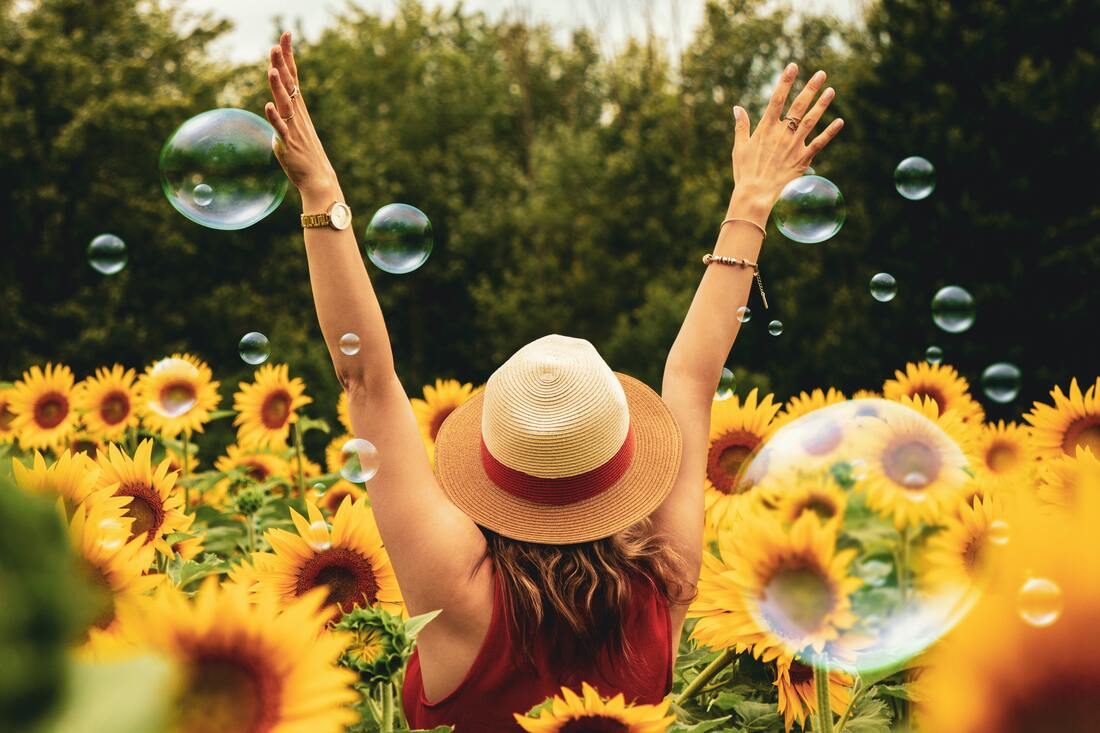 Woman in hat, sunflowers, bubbles