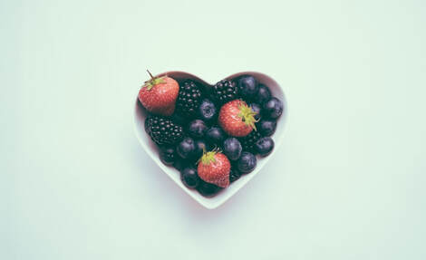 heart shaped bowl with berries